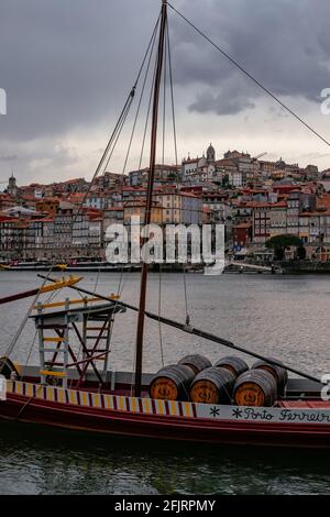 Traditional and Iconic Rabelo Boats moored in Douro River - Cloudy Sky with Rain - Porto, Portugal Stock Photo
