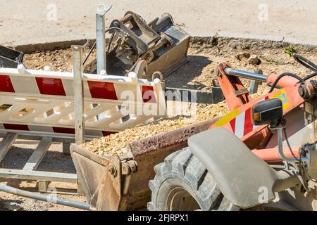Road construction site with excavator and sand, road construction work in progress Stock Photo