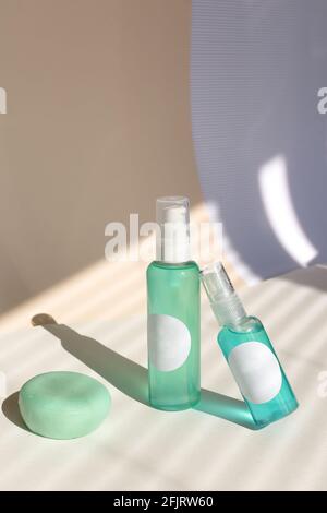 Cleansing natural cosmetics - face wash cleansing gel, smoothing toner, striped shadow background. Stock Photo