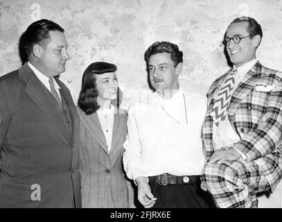 Set Visitor J.A. KRUG new Vice President of MPPDA with FRANCES RAMSDEN Director PRESTON STURGES and HAROLD LLOYD on set candid in October 1945 during filming of THE SIN OF HAROLD DIDDLEBOCK aka MAD WEDNESDAY 1947 director / original screenplay PRESTON STURGES producers Howard Hughes and Preston Sturges California Pictures / United Artists Stock Photo