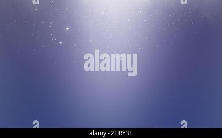 Abstract blue background. White bokeh or dust, lights on a blue background. Stock Photo