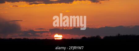 Panorama of sunset on the horizon and red sky with clouds. Stock Photo