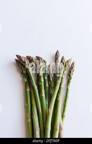 Bundle of fresh raw green asparagus on a white background. Stock Photo