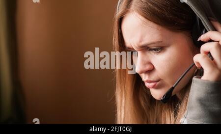 Confused girl operator with headset. Remote work from home in a call center Stock Photo
