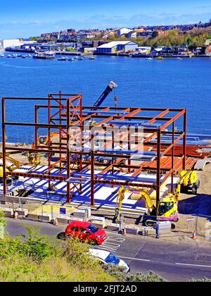 Steel framed 3 storey building being constructed by the riverside Stock Photo