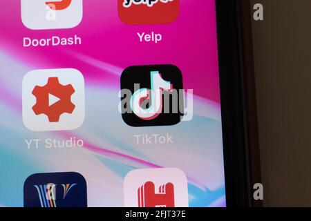 New York, USA - 26 April 2021: TikTok app logo on phone screen close-up top view, Illustrative Editorial Stock Photo