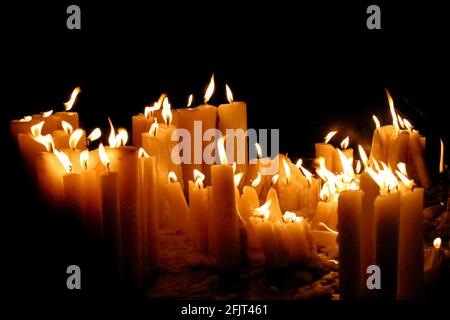 lit prayer candles in a dark church Photographed in Zagreb, Croatia Stock Photo