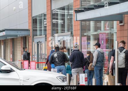 Dundee, Tayside, Scotland, 26.04.21: Large queues wait to enter TK Maxx at the Gallagher Retail Park in Dundee, as Scotland leaves its second lockdown and restrictions are relaxed, and the shops open up again. Credit: Barry Nixon Stable Air Media/Alamy Live News Stock Photo