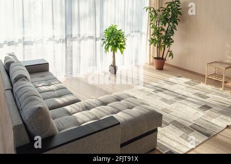 Modern interior with big sofa and a large windows - Image Stock Photo