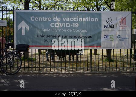 Covid-19 Vaccination Centre, 'Centre de vaccination', Salle Olympe de Gouges, Square de la Roquette, 15 Rue Merlin, 75011, Paris, France - April, 2021 - exterior sign with woman walking past Stock Photo