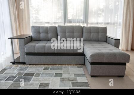 Modern interior with big sofa and a large windows - Image Stock Photo