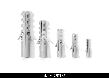 Group of Plastic dowels isolated on a white background. Wall plugs in different sizes Stock Photo