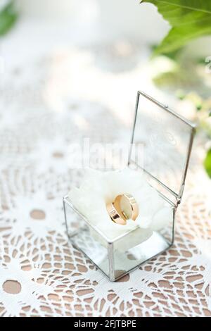 Wedding rings on white rose in little box. Stock Photo