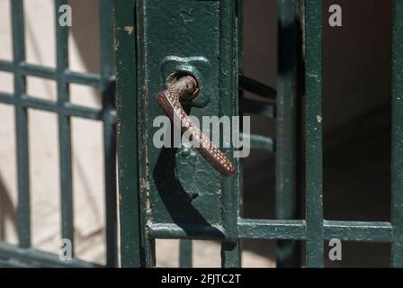 Old retro vintage iron lock and handle of metal garden door closeup Stock Photo