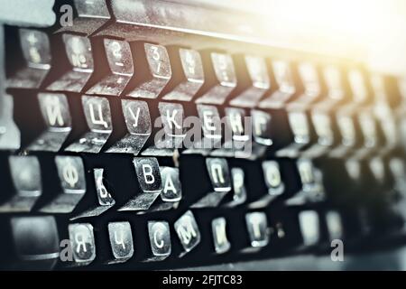 Outdated typewriter close-up. Broken keyboard with Russian letters. Background Stock Photo