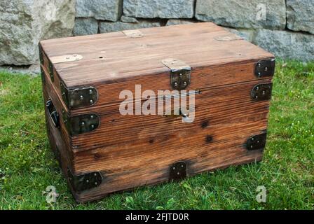 Old retro vintage wooden chest on house garden closeup Stock Photo