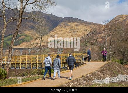 Glenfinnan, Lochaber, UK. 26th April 2021. Jacobite Steam Train first trip of 2021 did not encourage very many  visitors to the newly built car park that leads to the new 'Glenfinnan Wee Harry Potter Bridge' which has been crowdfunded by the  community who raised £8,467 to allow them to build a bridge to cross the River Finnan to keep the normal 350,000 tourists  that arrive each year safe and off of the busy road that runs between Fort William and Mallaig. Stock Photo