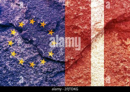 Flags of EU and Latvia painted on cracked wall background - Politics alliance concept Stock Photo