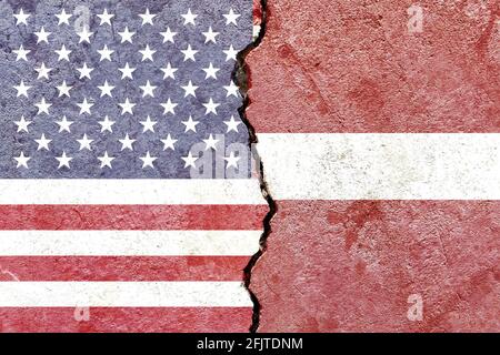 Flags of USA and Latvia painted on cracked wall background - Politics conflicts concept Stock Photo