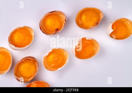 Broken chicken's eggs on white background. Stock Photo