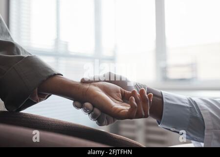 Close-up of doctor measuring the pulse of his patient at hospital Stock Photo
