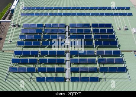 Hot water heaters and solar panels installed on the building roof Stock Photo