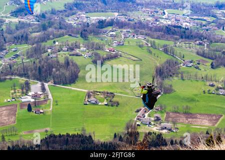Panorama of the valley from the Ere Refuge. Close up. The first moments of the flight of a paraglider. San Gregorio nelle Alpi, Belluno, Italy Stock Photo