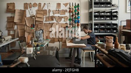 African female artisan using a sewing machine in her artisnal studio Stock Photo