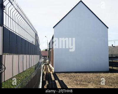 white house without windows. Empty house on the plot. Stock Photo