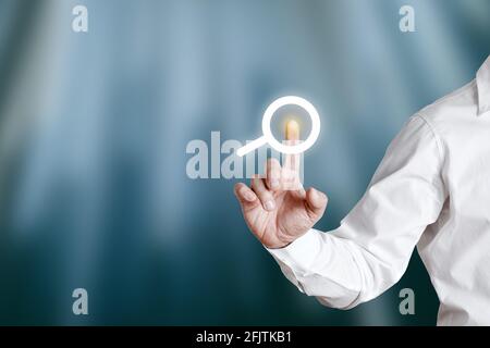 Businessman pressing internet search icon or button on a virtual display screen. Stock Photo