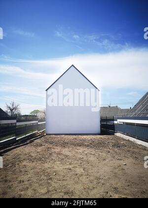 white house without windows. Empty house on the plot. Stock Photo