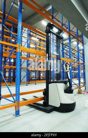 Walking Pallet Stacker in a newly-constructed empty warehouse. Stock Photo