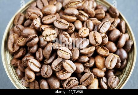 Roasted coffee beans in a bowl, selective focus. Stock Photo