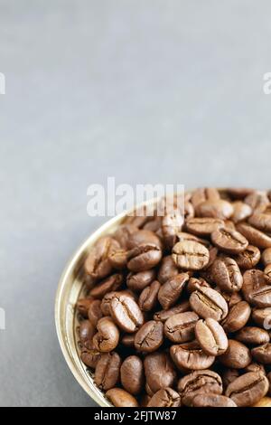 Roasted coffee beans in a bowl, selective focus, space for text. Stock Photo