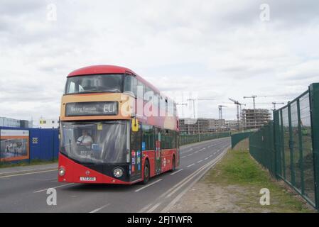 Red London bus at Barking Riverside beside new housing Stock Photo