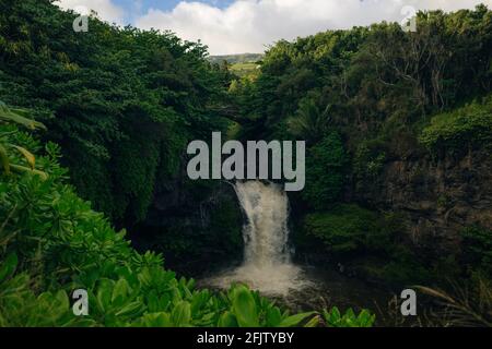 Dramatic series of waterfalls of Ohe'o Gulch cascading down a rocky under a bridge, in Haleakala National Park, Kipahula, Maui, Hawaii, USA. High qual Stock Photo
