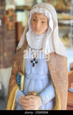 France, Tarn, Dourgne, entrance to the Benedictine Abbey of Sainte Scholastique (located on the Way of St. James), statue in plaster and resin of Saint Scholastica hand painted by Sister Mercedes Stock Photo