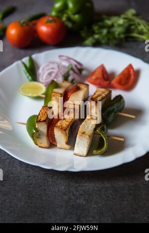Cooked food paneer or grilled cottage cheese background. Close up, selective focus. Stock Photo