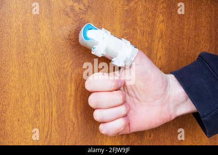 A man with a cast on his broken thumb. Safety at work. Stock Photo