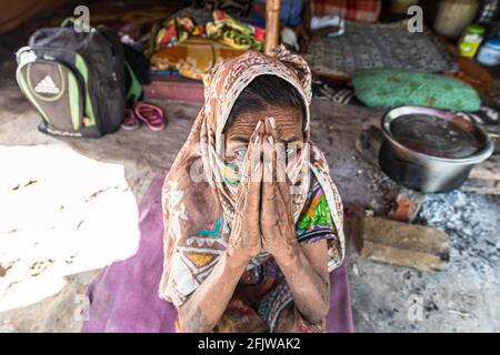 portrait of indian senior woman begging on road during lock down in india. Stock Photo