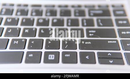 Selective focus of a keyboard on a laptop with a grey background Stock Photo