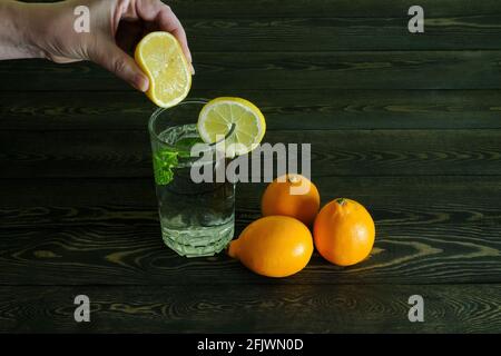 water in a glass with lemon and mint leaves Stock Photo