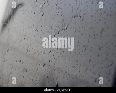 Drops of clean water on the surface of a dark washed car hood Stock Photo