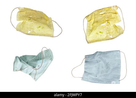 Four colored paper Covid masks ready for the garbage, isolated on white for your easy extraction. Stock Photo