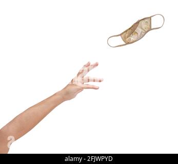 Hand and arm throwing away soiled covid face mask, isolated on white with copy space. Stock Photo