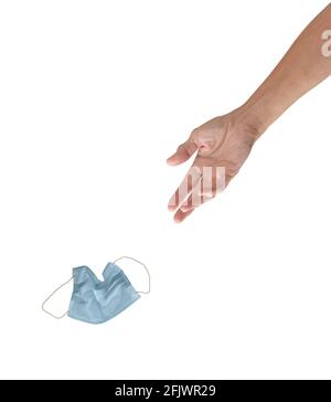 A lady's hand tosses a used blue face mask toward a trash recepticle or similar target, isolated on white with copy space.  A single headline screamin Stock Photo