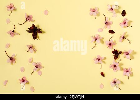 Creative flat lay flowers composition. Light pink flowers on pastel yellow background. Wedding. Birthday. Valentines Day. Mother's day. Flat lay, top Stock Photo