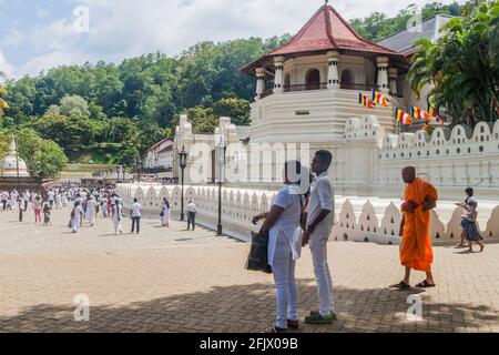 KANDY, SRI LANKA - JULY 19, 2016: White clothed Buddhist devotees visit Temple of the Sacred Tooth Relic during Poya Full Moon holiday. Stock Photo