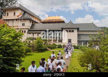 KANDY, SRI LANKA - JULY 19, 2016: White clothed Buddhist devotees in the Temple of Sacred Tooth Relic during Poya Full Moon holiday. Stock Photo