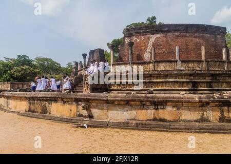 POLONNARUWA, SRI LANKA - JULY 22, 2016: Children in school uniforms visit Vatadage in the ancient city Polonnaruwa, Sri Lanka Stock Photo